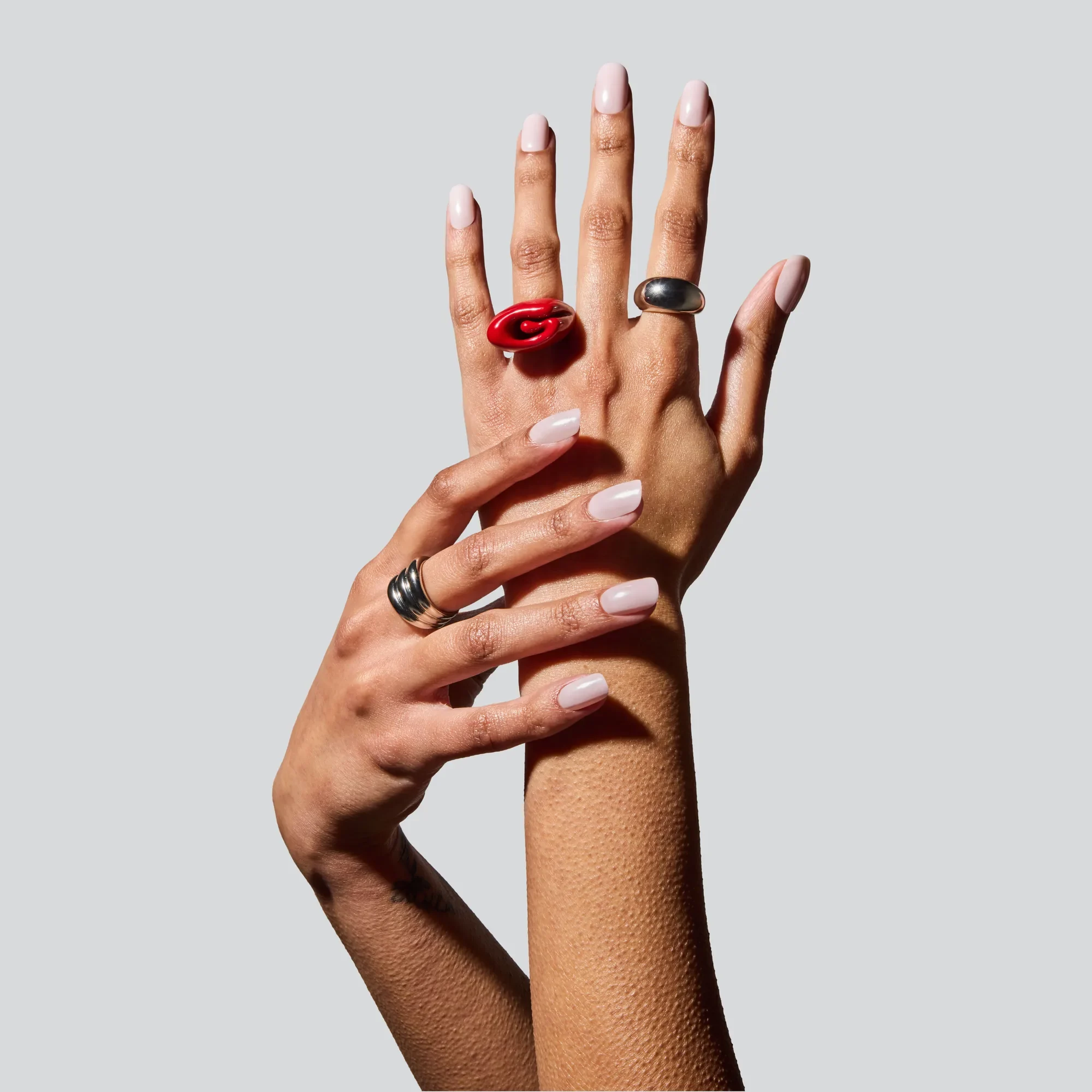 Two hands wearing glossy Glaize press-on nails