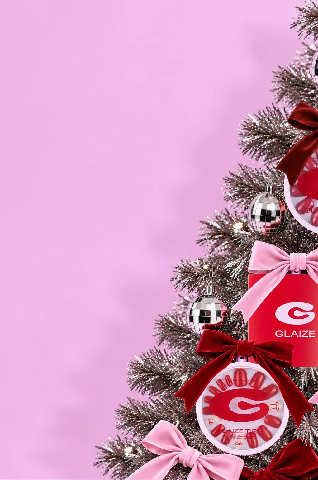 Glaize press-ons and festive bows decorating a silver Christmas tree