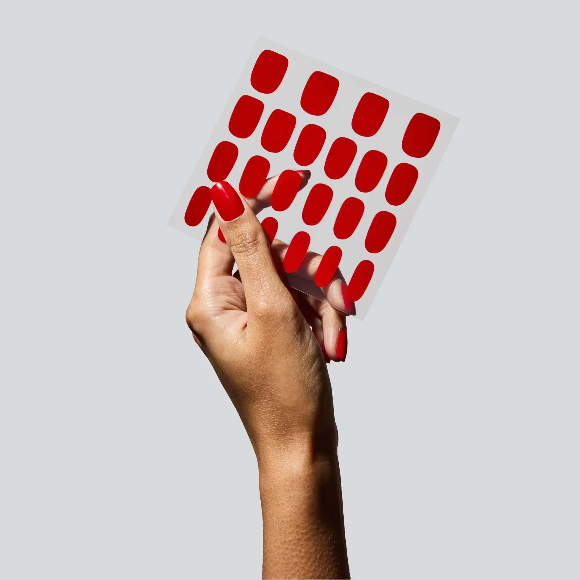 Hand holding Glaize standard fit stick-on gel nails