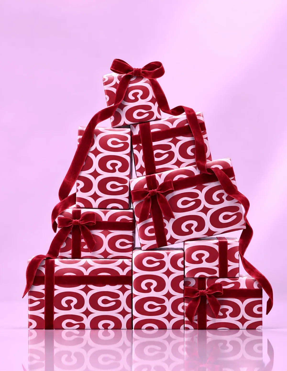 A tree of presents wrapped in Glaize paper and red velvet ribbon