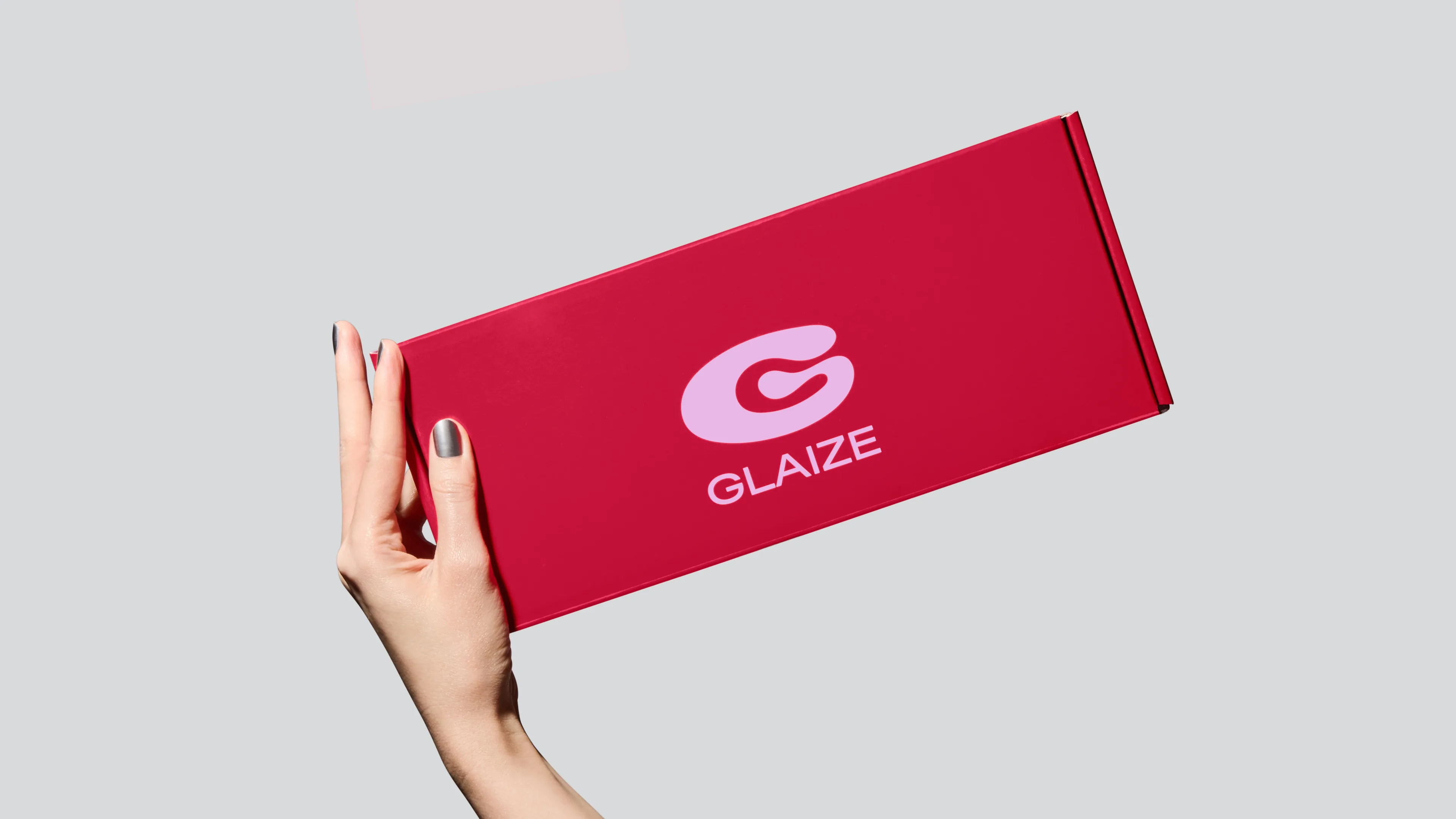 Hand holding Glaize starter kit packaging